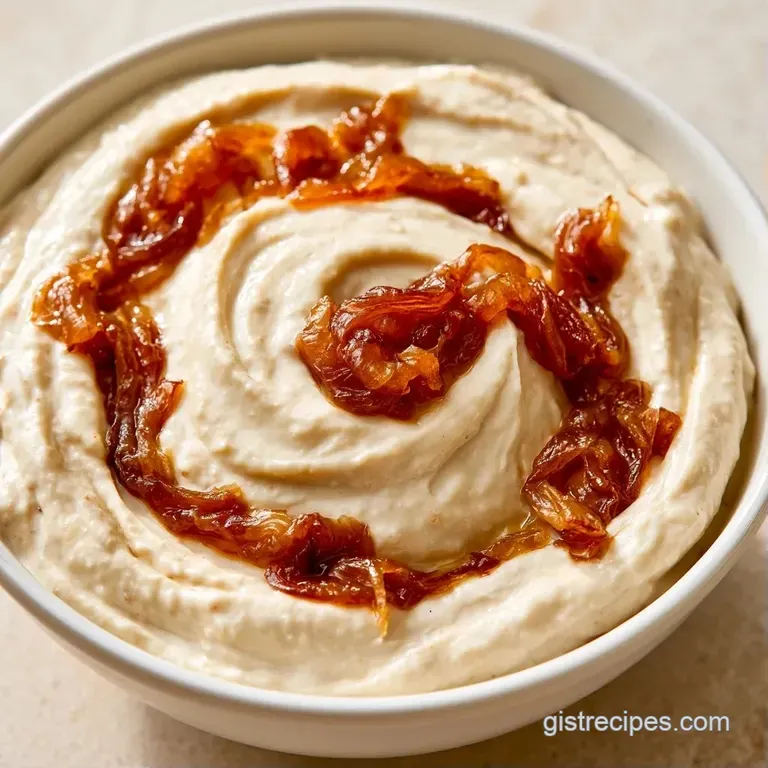 A white bowl of thick savory cream dip surrounded by golden potato chips and a sprig of fresh green parsley.